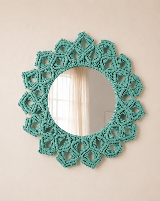 Teal macrame mirror on a beige wall